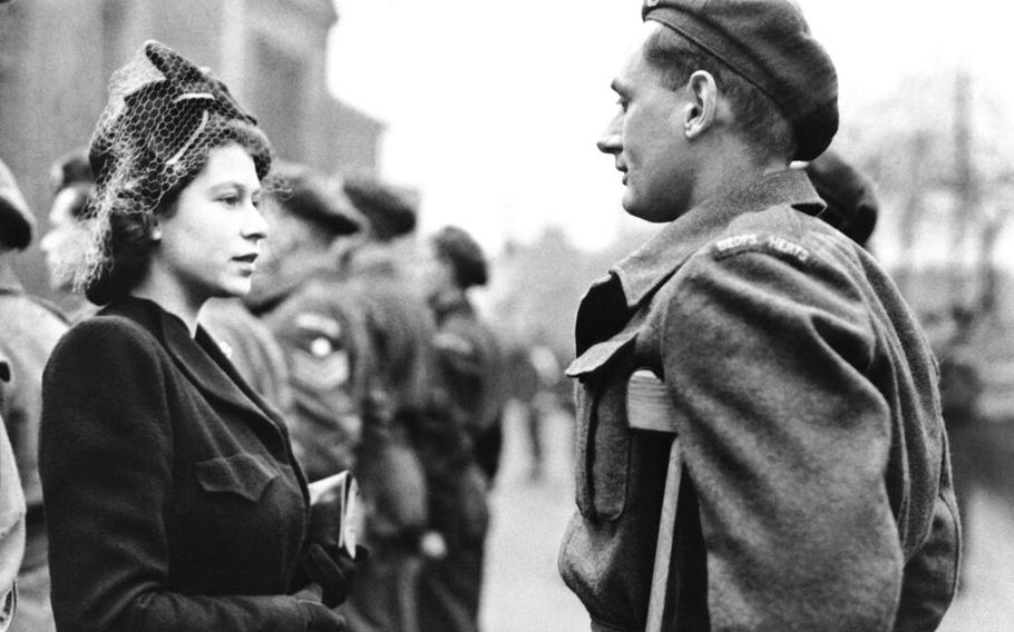 Then- Princess Elizabeth of England talks to Private Rupert John Worth during a visit to Bedford, England on Feb. 14, 1946.