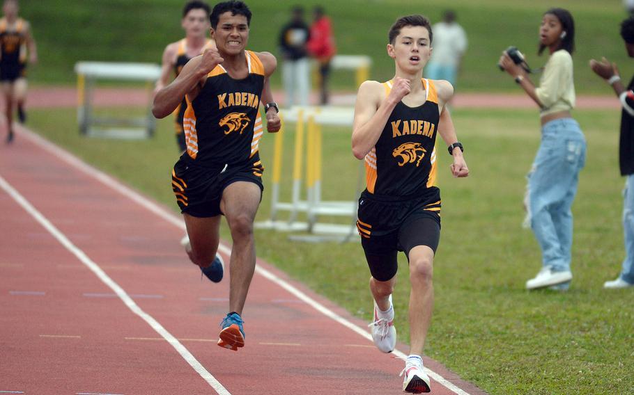 Kadena's Jeremiah Williams and William Rhoades head for the finsih of the 3,200 during Friday's first day of a two-day Okinawa track and field meet. Williams and Rhoades clocked 11:08.60 and 11:08.85 to finish 1-2.
