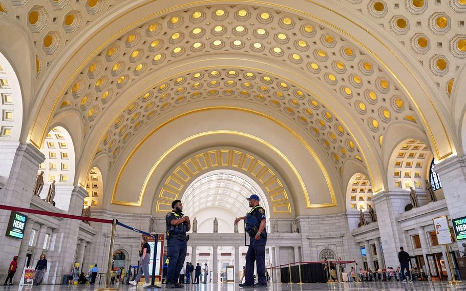 Two police officers under archways in the main lobby.