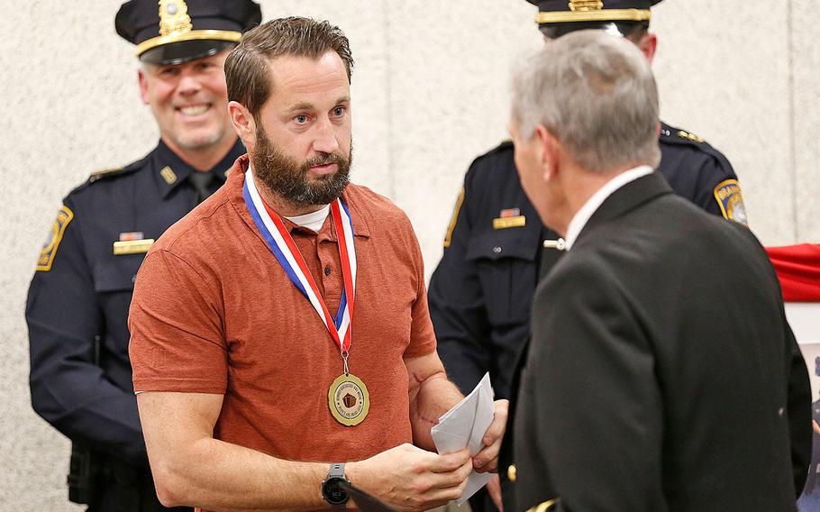 Braintree police officer William Cushing receives a World War II Peace Medal at the Braintree police station on Nov. 11, 2021.