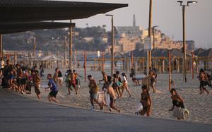 Beachgoers leave the beach.