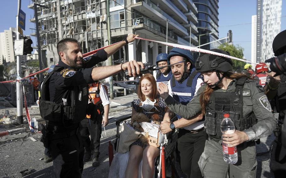 A woman is pushed in a wheelchair.