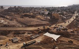 Construction workers build a bridge linking the eastern and western parts of Derna, which was divided by the dam collapse following recent flooding caused by Mediterranean storm Daniel, in Derna, Libya, Monday, Sept. 18, 2023. (AP Photo/Muhammad J. Elalwany)