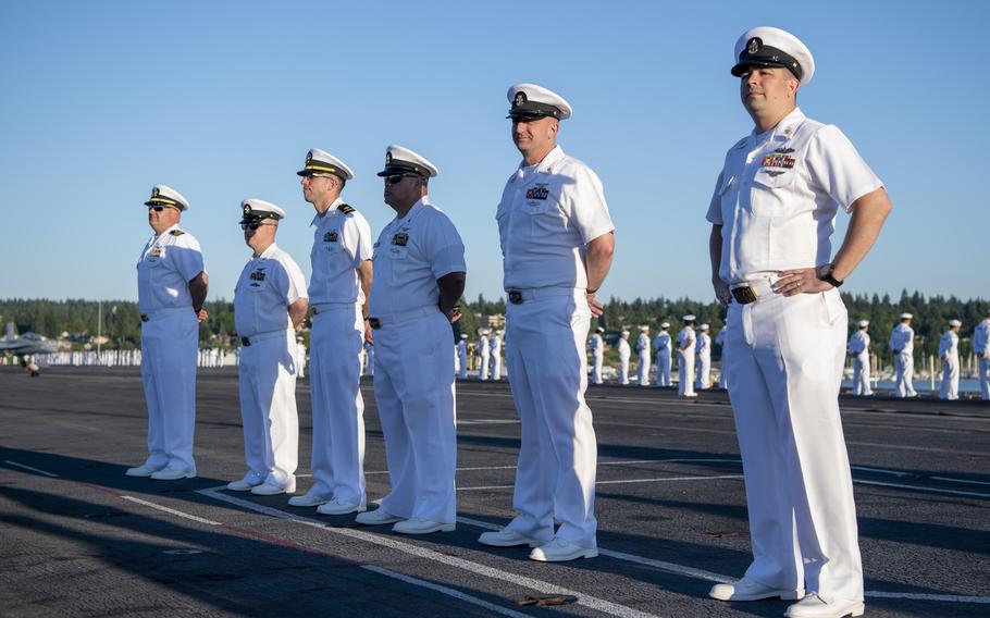 Sailors line the rails on the flight deck of the aircraft carrier USS Nimitz on its return to homeport.