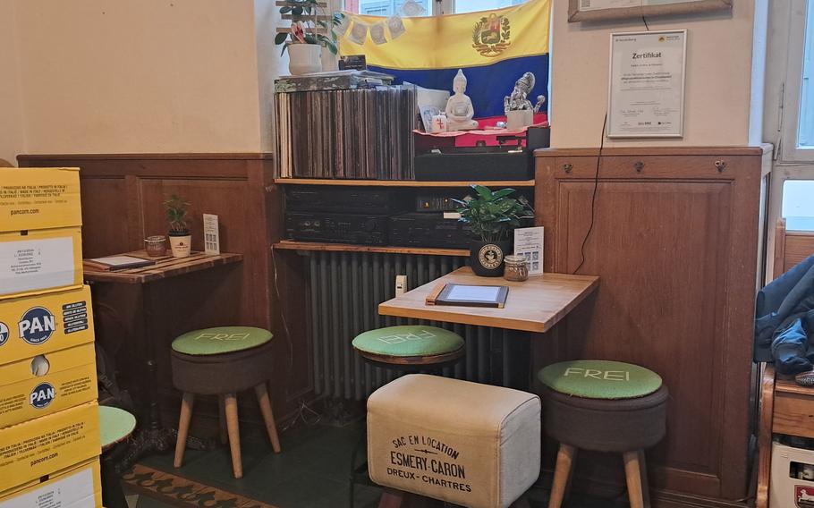 A Venezuelan flag blends into the seating area of the restaurant portion of Rada Arepa in Heidelberg, Germany. Directly opposite are the cafe and roastery. The restaurant used to be called Arepas World. 