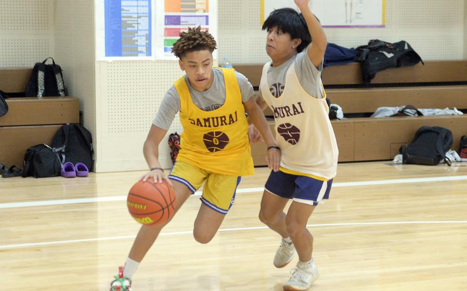 Matthew C. Perry's boys basketball backcourt is a mix of youth and experience, with freshman Jahiion Francois, left, and senior Eddie Pacleb.