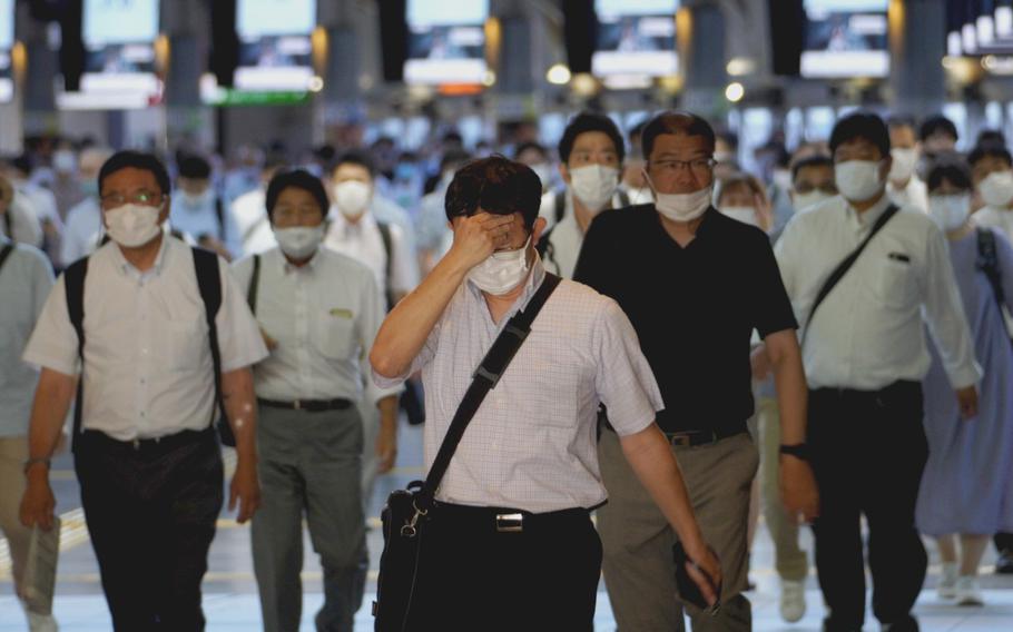 Commuters depart Shinagawa Station in central Tokyo around 7 a.m. Aug. 20, 2021.