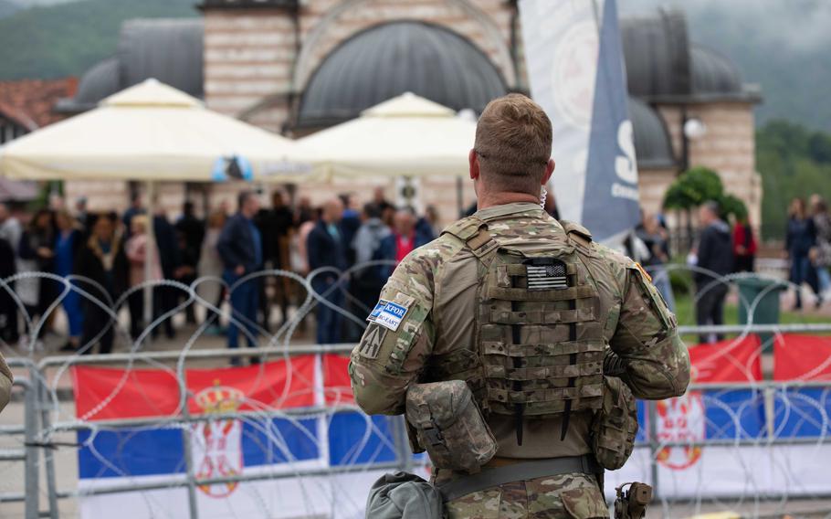 Kosovo Force Regional Command-East soldiers stationed at Camp Nothing Hill watch protests in Leposavici, Kosovo, that began on May 26, 2023.