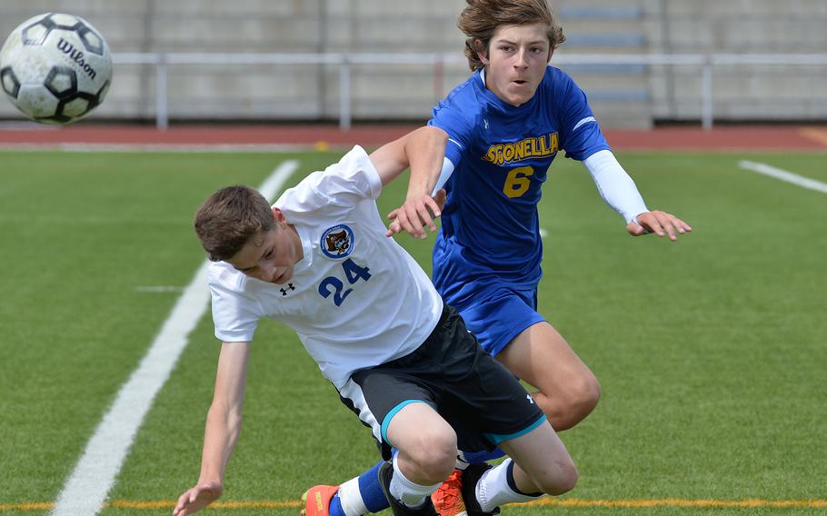 Sigonella’s Mikołaj Czernielewski knocks the ball away from Brussels’ Conrad Adams in a Division III semifinal in Kaiserslautern, Germany, May 17, 2023. The Jaguars beat the Brigands 6-0 to advance to Thursday’s championship game against Ansbach.