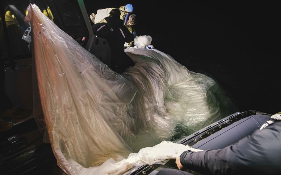 Sailors assigned to Explosive Ordnance Disposal Group 2 recover a high-altitude surveillance balloon off the coast of Myrtle Beach, S.C., Feb. 5, 2023.