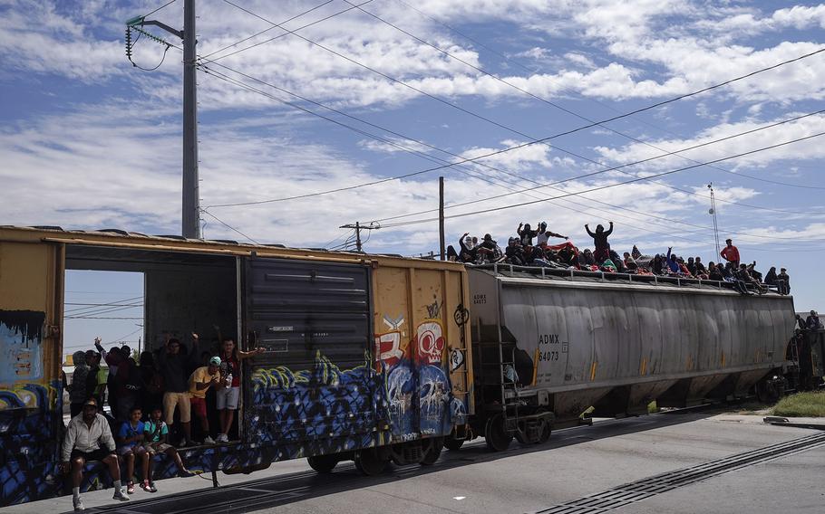 Hundreds of migrants ride atop a freight train arriving in Ciudad Juárez from the city of Chihuahua to the south. The rail line is a heavily traveled route for migrants coming from the south. 