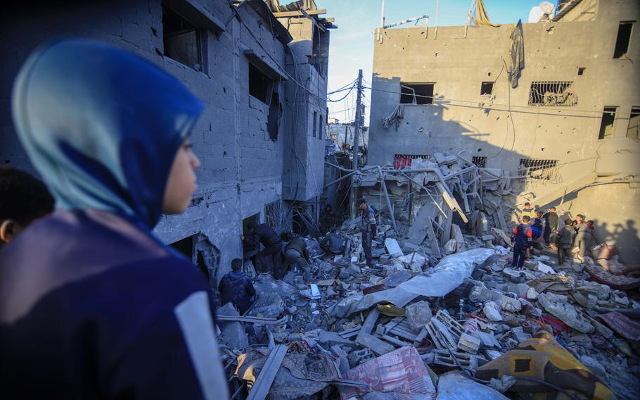 Palestinians search the rubble of a destroyed building following an Israeli airstrike in the Nuseirat refugee camp in central Gaza on Feb. 28, 2024.