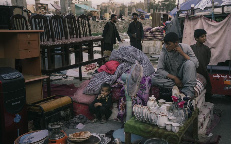 A family waits for buyers in a sprawling market near Ghazi Stadium. 