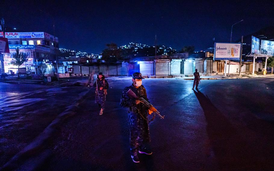 Taliban fighters in their new uniforms station themselves at a large traffic junction for a nightly security checkpoint, in Kabul, Afghanistan, Sunday, September 5, 2021. 