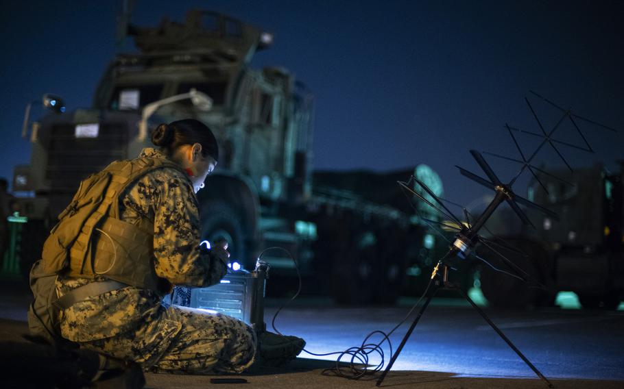 Cpl. Estefania Liraortega, a radio operator for Marine Wing Communications Squadron 18, checks an AN/PRC-117F multiband, multimission manpack radio during the Active Shield exercise at Marine Corps Air Station Iwakuni, Japan, Oct 27, 2021.