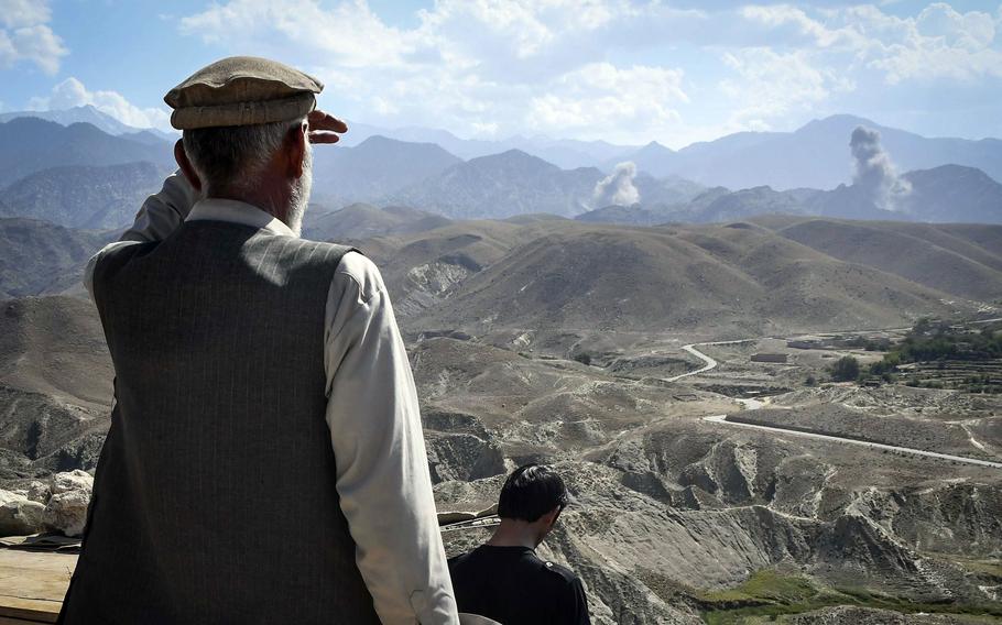 An Afghan policeman watches the aftermath of strikes by U.S. F-16 jets against Islamic State fighters in Nangarhar province, Afghanistan July 7, 2018. The number of declared U.S. military airstrikes around the world in 2021 fell to the lowest total since 2006, said a report published by May 10, 2022 by the London-based nonprofit group Airwars.