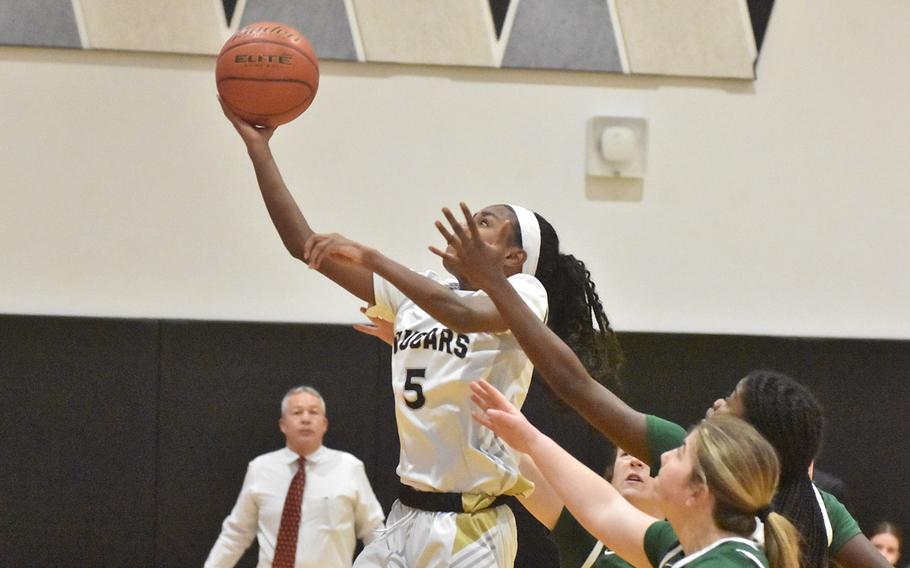 Naples’ VaNae Filer sticks out a hand as Vicenza’s Alexandria Taylor misses a layup in the Wildcats’ 34-32 victory Friday, Feb. 2, 2024, at Vicenza, Italy.