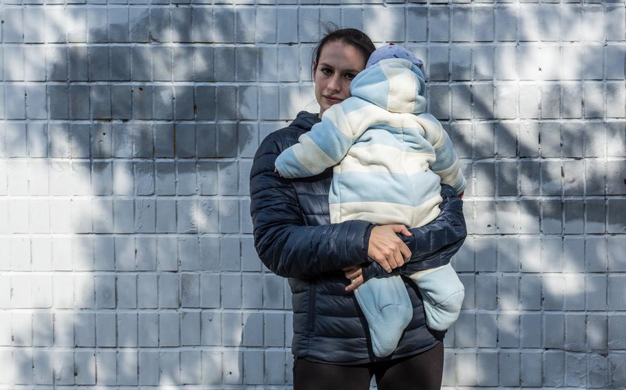 Olha Shapkova, 28, poses for a portrait with her son near their home in Kyiv, Ukraine on Sept. 25, 2022. Olha's husband Volodymyr is a military medic and is held prisoner supposedly in Olenivka. 