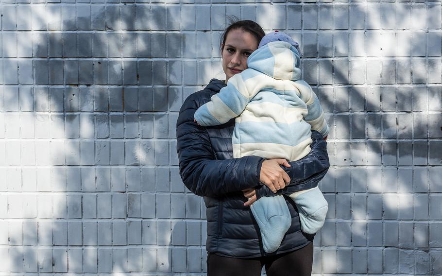 Olha Shapkova, 28, poses for a portrait with her son near their home in Kyiv, Ukraine on Sept. 25, 2022. Olha's husband Volodymyr is a military medic and is held prisoner supposedly in Olenivka. 