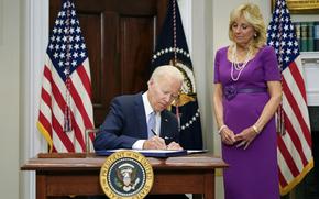 President Joe Biden signs into law S. 2938, the Bipartisan Safer Communities Act gun safety bill, in the Roosevelt Room of the White House in Washington, Saturday, June 25, 2022. First lady Jill Biden looks on at right. (AP Photo/Pablo Martinez Monsivais)