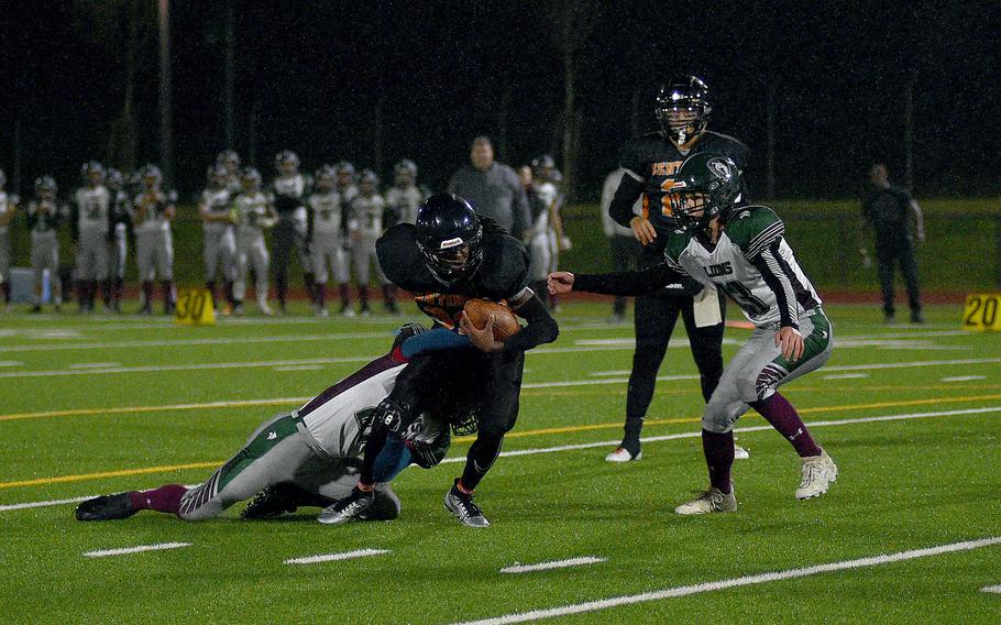 AFNORTH's Markuss Grebezs tackles Spangdahlem running back Messiah Smith during the DODEA-Europe Division III championship game on Oct. 29, 2023, at Spangdahlem High School in Spangdahlem, Germany. coming to help on the tackle is the Lions' Everett Reeves.