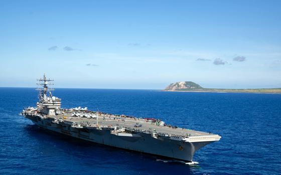 The aircraft carrier USS Ronald Reagan sails near Iwo Jima, known in Japan as Iwo To, in the Philippine Sea, May 22, 2021.