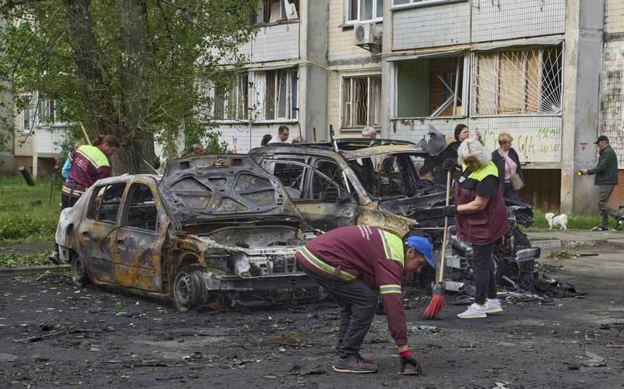 Burned out cars and damaged structures in the aftermath of a Russian strike.