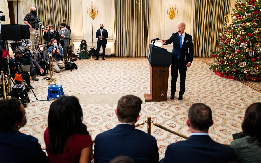 President Biden answers questions at the White House in December 2021, in a brief, informal exchange with reporters.