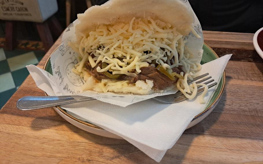 At Rada Arepa in Heidelberg, Germany, the arepa pelua adds the fiery kick of jalapeno peppers to the shredded beef, black beans and cheese stuffed inside the circular cornmeal arepa. 