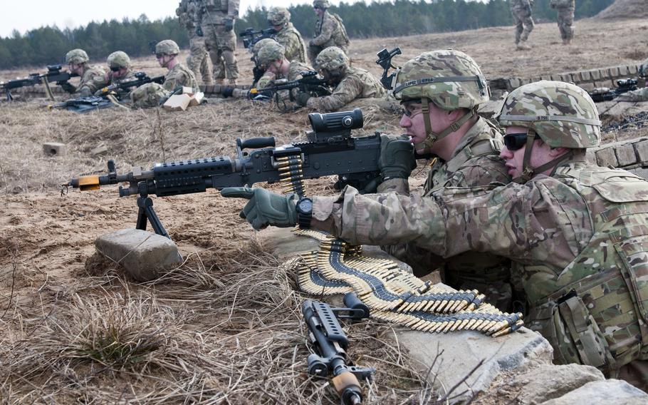 U.S. Army Cpl. Ronald Face, right, and Spc. Miguel Lopez, of the 2nd Cavalry Regiment, scan for enemy activity during an exercise at Pabrade Training Area, Lithuania, March 4, 2015. While U.S. troops have been active in Eastern Europe on a rotational basis for years, Lithuania is asking for a permanent presence. 