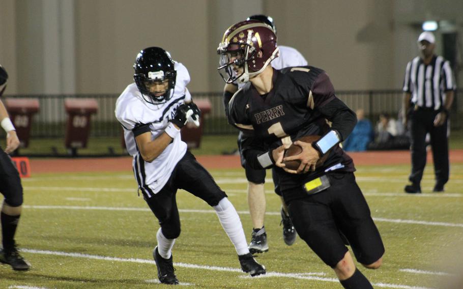 Matthew C. Perry quarterback Jordan Wooten tries to outrun Zama defender Vander Perkins.