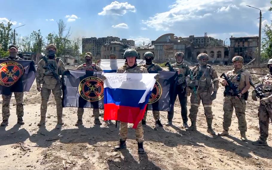 In this handout photo taken from video and released by Prigozhin Press Service Saturday, May 20, 2023, Yevgeny Prigozhin, the head of the Wagner Group military company speaks holding a Russian national flag in front of his soldiers in Bakhmut, Ukraine. Prigozhin claims his forces have taken control of the city of Bakhmut after the longest and most grinding battle of the Russia-Ukraine war, but Ukrainian defense officials have denied it. In a video posted on Telegram, Prigozhin said the city came under complete Russian control at about midday Saturday. 