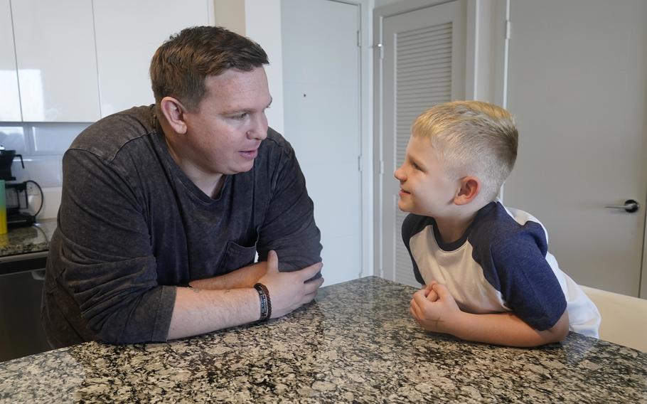 Associated Press investigative reporter James LaPorta and his son Joel, 5, sit at their home, Tuesday, Sept. 7, 2021, in Boca Raton, Fla. LaPorta recalls a boy he encountered in Afghanistan back in 2013 while serving as a Marine.
