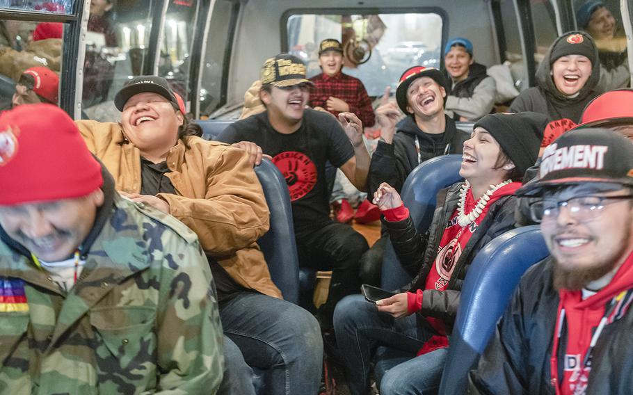 American Indian Movement youth members from Rapid City hang out in the bus they use to help the homeless while they help at the Pow Wow to honor the AIM Warriors of Wounded Knee of 1973 in Wanblee, S.D., on the Pine Ridge Indian Reservation on Feb. 26, 2023. 