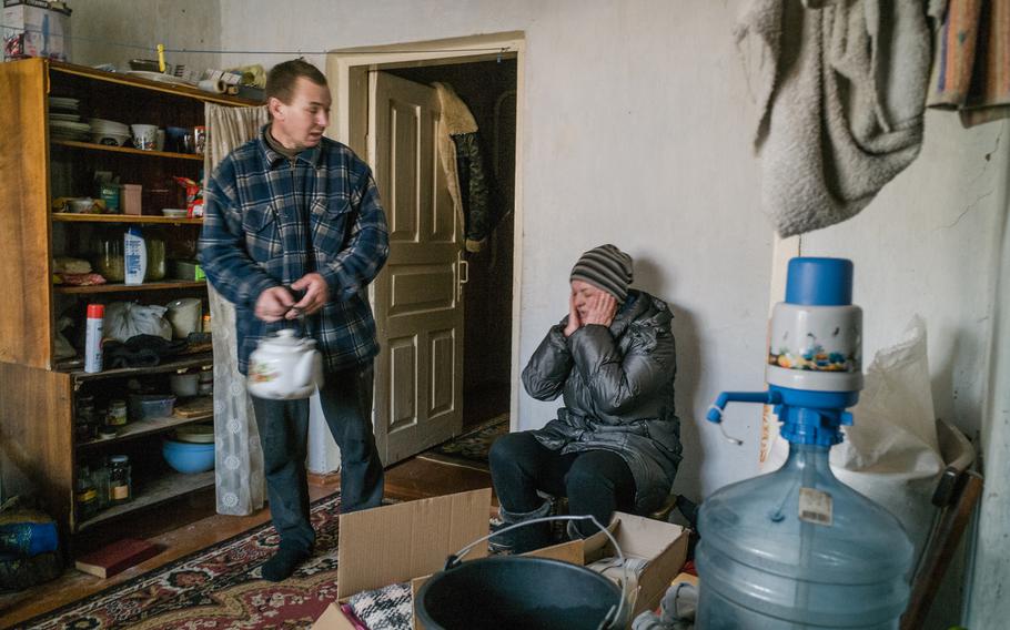 Natasha, 39, and Anton Dyadchenko, 41, in their house in Lvove.