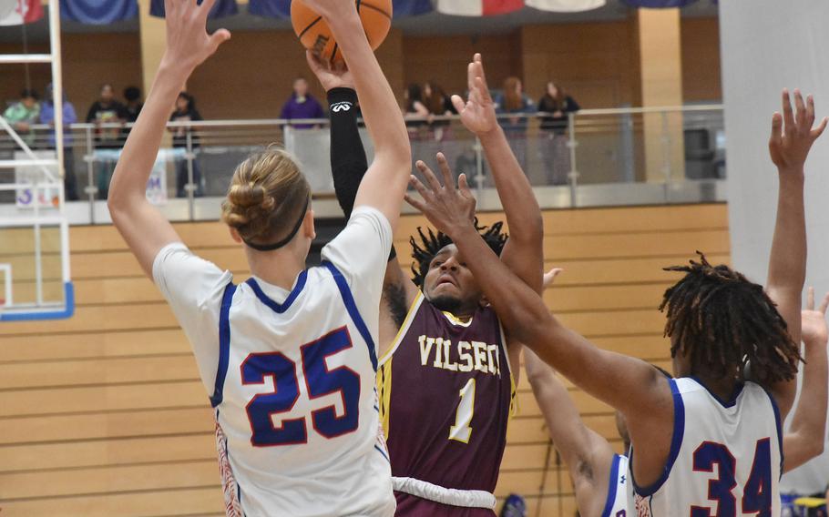 Vilseck’s Brandon Goins goes up for a shot while Ramstein’s Kelan Vaughn, left, and Tyrell Edwards defend Friday, Feb. 16, 2024, in a Division I semifinal in the DODEA European Basketball Championships at Wiesbaden, Germany.