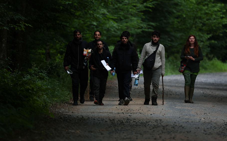 A group of migrants (mainly from Yemen) walk with activist Agata Kluczewska, who runs a local migrant support group, after they crossed Belarusian-Polish border in Grudki, Poland, June 4, 2024. 