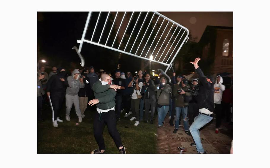 Pro-Palestinian protesters and pro-Israel activists clash at an encampment at UCLA early Wednesday, May 1, 2024. 