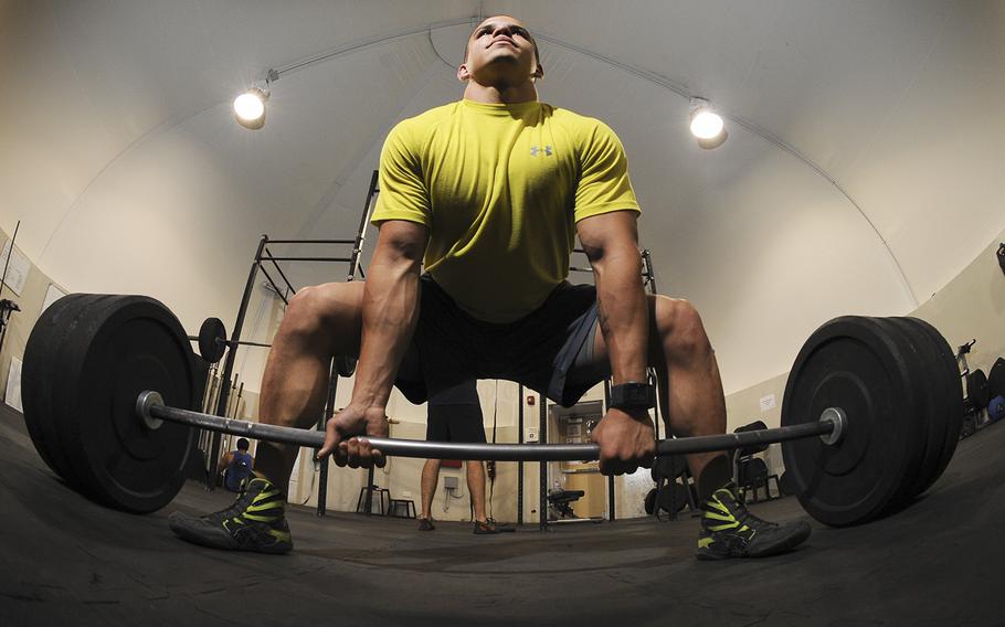 A U.S. airmen does a deadlift during a workout at an undisclosed location in Southwest Asia on Sept. 11,2013. 