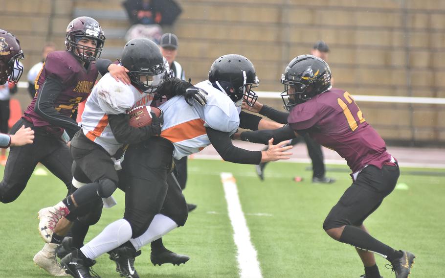 Spangdahlem's Adam Jalomo runs into a teammate while he's surrounded by Baumhlder Bucs on Saturday, Oct. 30, 2021, in the DODEA-Europe Division III title game at Kaiserslautern, Germany.