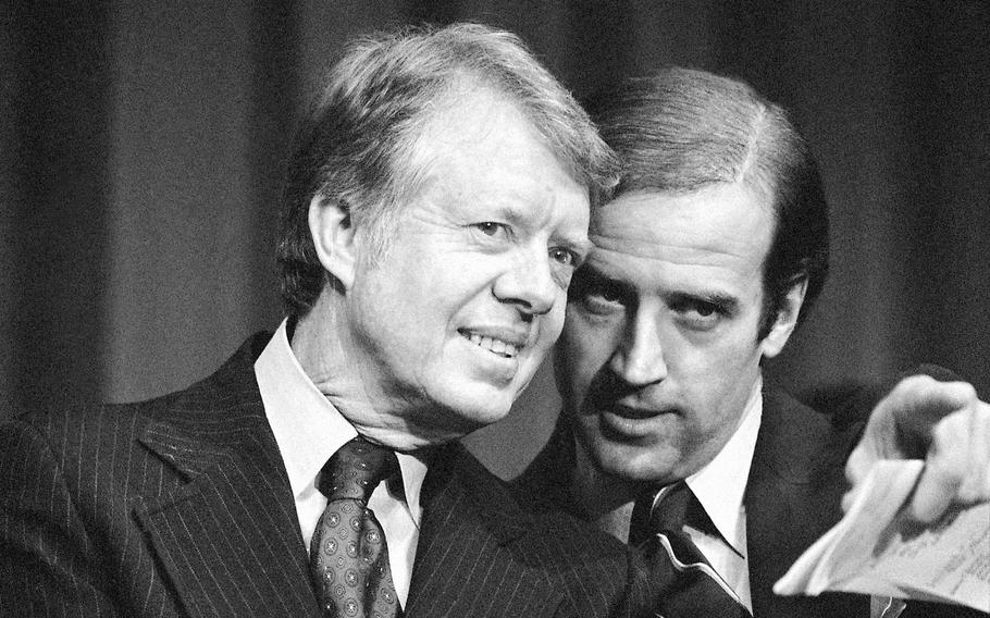 In this Feb. 20, 1978, file photo, President Jimmy Carter listens to Sen. Joseph R. Biden, D-Del., as they wait to speak at fund raising reception at Padua Academy in Wilmington, Del. Biden says he plans to deliver the eulogy at the funeral of Carter, who remains under hospice care at his home in south Georgia.