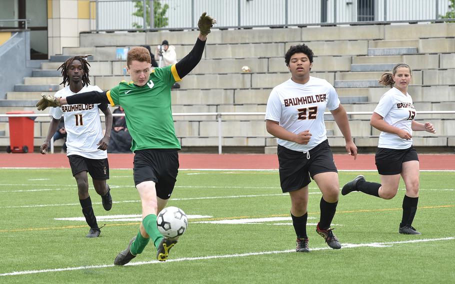 Alconbury's Gethin Moose tries to toe-poke the ball into the net during a match May 16, 2023, at Kaiserslautern High School in Kaiserslautern, Germany. In the background, from left, are Baumholder's Jesse Bogan, Kurt Aziz and Ashlyn Brech.