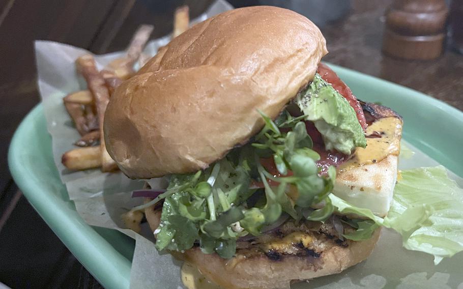 The veggie tofu burger from An Solas Irish Pub in Shibuya, Tokyo, is topped with fresh avocado, tomatoes, red onions, radish sprouts, lettuce and balsamic sauce. It's served with a side of fries.