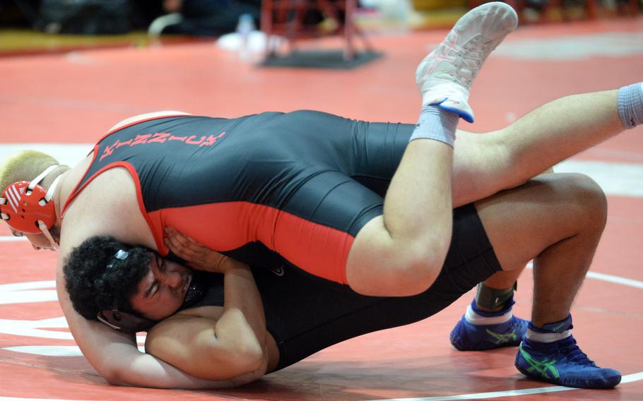 Nile C. Kinnick's Bobby Crisafulli gets the win over Perry's Jayden Santiago in the Far East heavyweight final.