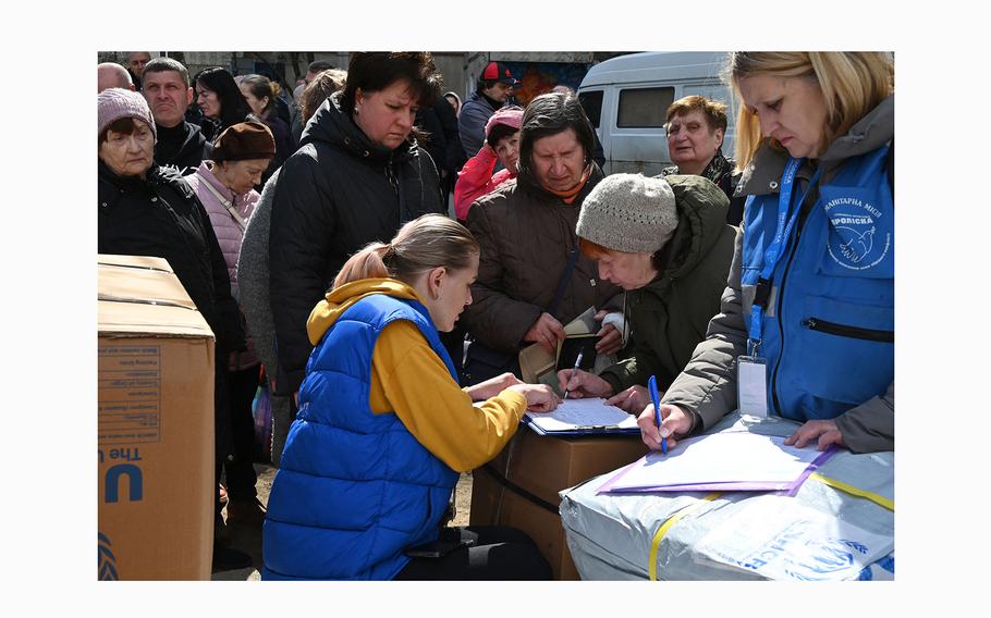 Local residents line up to receive humanitarian aid in Kharkiv, on April 6, 2024, amid the Russian invasion in Ukraine. 