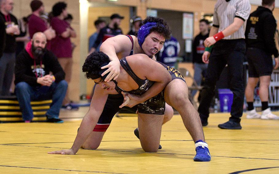 Kaiserslautern's Freeman Allen grapples with Stuttgart's Sharif Elmas in the 175-pound final during a DODEA wrestling sectional meet on Feb. 3, 2024, at Stuttgart High School in Stuttgart, Germany.