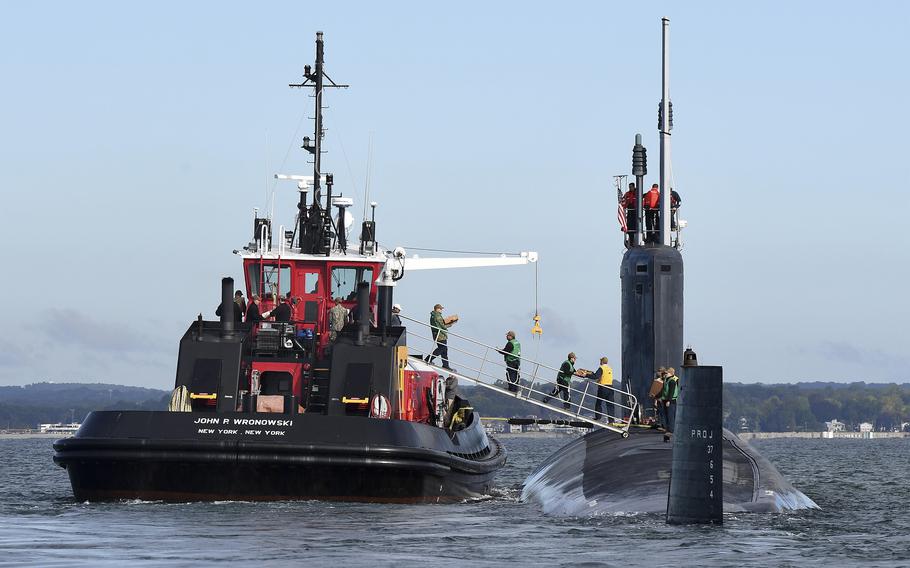 The U.S. Navy Virginia-class fast-attack submarine USS Oregon is resupplied from the tug boat John P. Wronowski during maneuvers on the Thames River near Naval Submarine Base New London, Oct. 6, 2022, in Groton, Connecticut. 