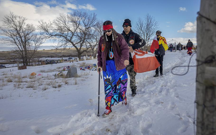 American Indian Movement Minnesota member Rachel Thunder makes her way to join a gun salute to honor the 1973 Wounded Knee Occupation in Wounded Knee, S.D., on Monday, Feb. 27, 2023. 