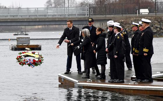 Sailors and the family of a submariner killed during the Thresher tragedy in 1962 throw a wreath in the water.