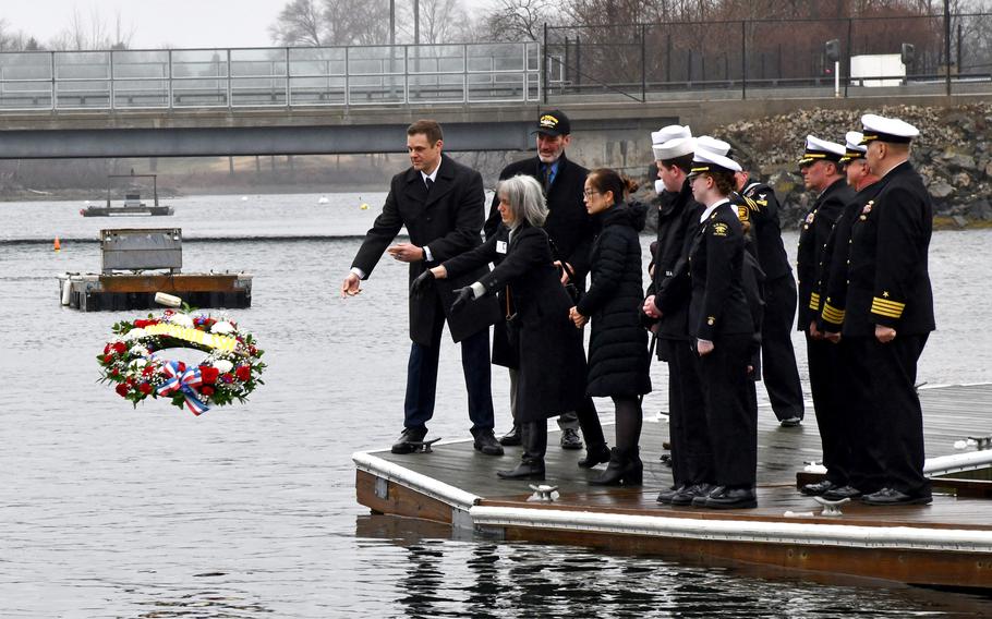 Sailors and the family of a submariner killed during the Thresher tragedy in 1962 throw a wreath in the water.